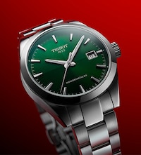 New green dial tissot watch on red background. Tap to shop new tissot arrivals image