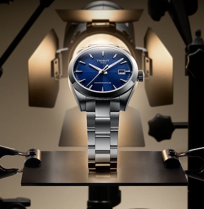 Blue dial Tissot gentleman watch on a gold mechanical background image