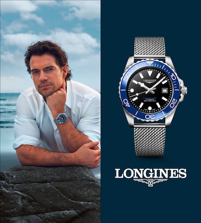 Henry Cavil wearing blue Hydroconquest watch. Elegance is a Attitude. Longines. Tap to shop image