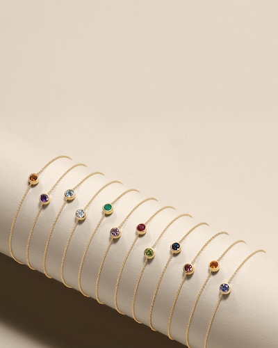 Birthstone bracelets on cream background. Tap to shop Birthstone jewellery image