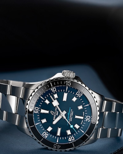 Blue Breitling Superocean 42 watch on satin background. Tap to shop Breitling Superocean collection image