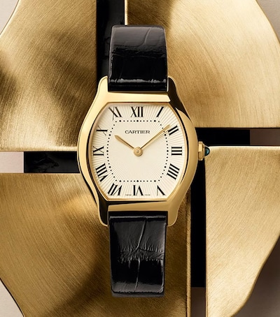 Image of Cartier Tortue watch on metal background. Tap to shop new Cartier Watches image