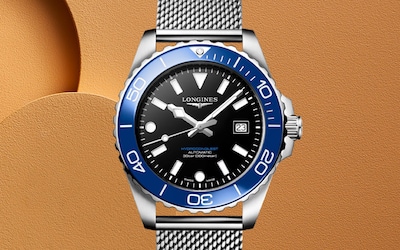 Blue and black Longines Hydroconquest on orange background. Tap to Shop image