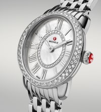 Close-up of a Michele silver watch with diamond-studded bezel, mother-of-pearl dial, Roman numerals, and a linked metal bracelet. image