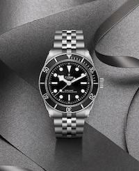 Tudor Black Bay Watch on Grey Background. Tap to shop Gifts for Him at Mappin & Webb this Christmas. image