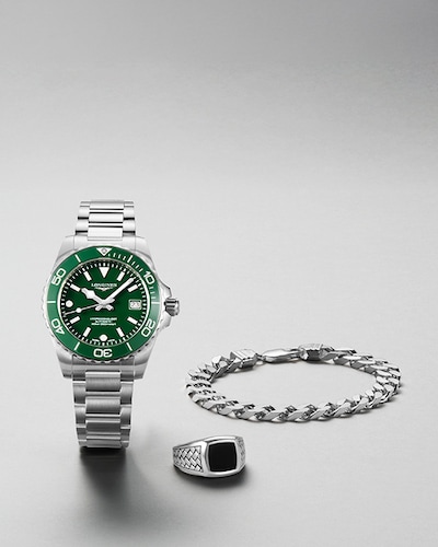 Image of Longines Hydroconquest watch with mens jewellery on grey background. Tap to shop Fathers Day gifts image