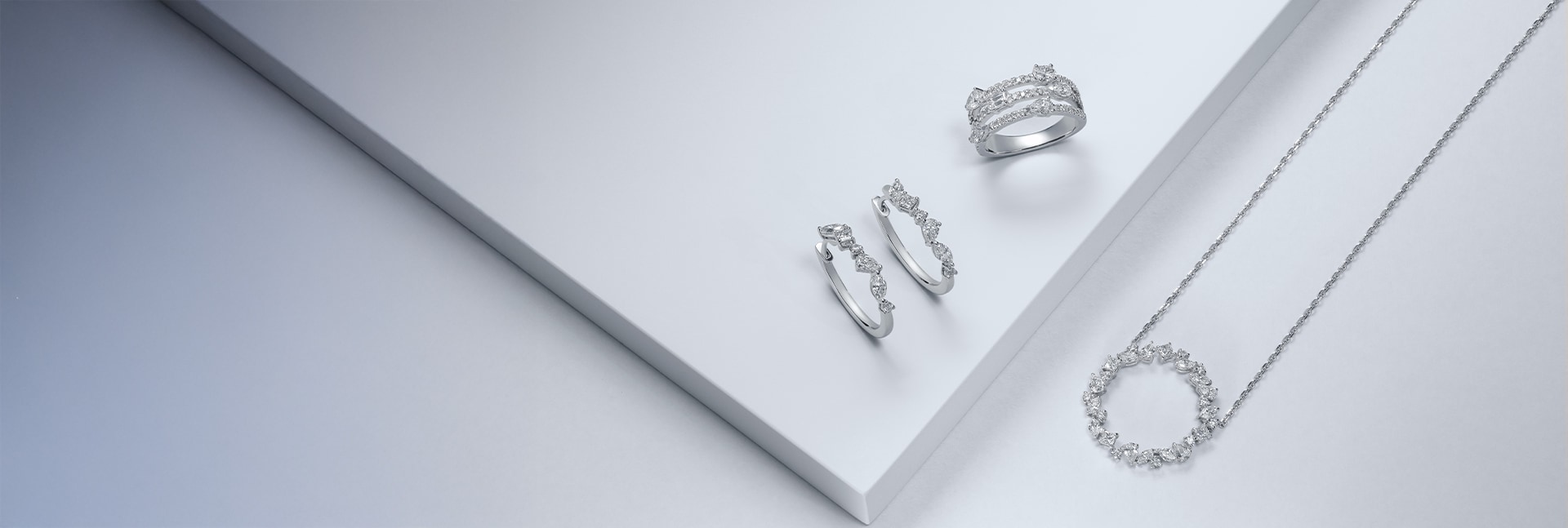 Diamond jewellery set on white stepped background image