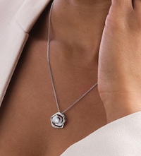 Woman wearing Mappin & Webb 250th collection White Gold rose necklace image