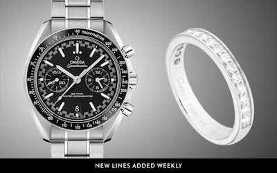 Image of Omega Speedmaster watch and Cartier White gold diamond ring. image