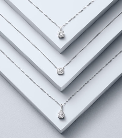 Diamond necklaces stacked on white step image