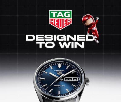 A TAG Heuer Carrera watch with a blue dial, accompanied by playful red characters, emphasizing the slogan "Designed to Win." image