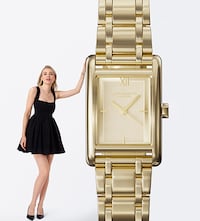 An image of lady in black dress standing next to the Olivia Burton gold watch. image
