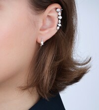 Repossi campaign imagery showing model wearing Repossi earrings. Tap to shop all Repossi image