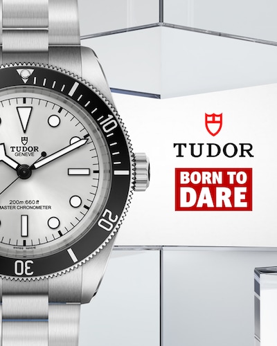 TUDOR Black Bay 68 with silver case and dial on blue and silver geometric background. Tap to shop image