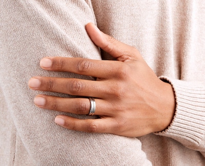Image of male model wearing titanium wedding ring. Tap to shop image