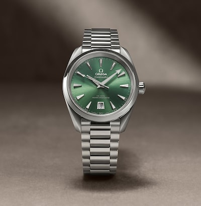 Womens Omega watch with green dial on nude background image